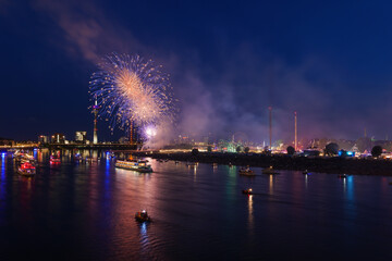 Outdoor night scenery of firework over Rhein River in D&uuml;sseldorf during Rheinkirmes Festival in Summer season.