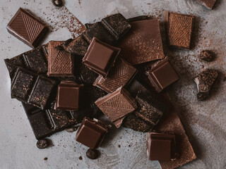 Chocolate Photo for posters and banners in top view Dark and milk crushed chocolate bars with cacao powder on textured background