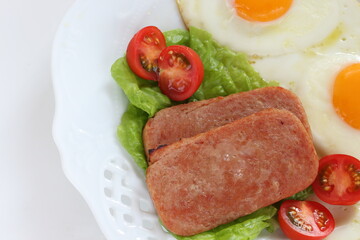 Luncheon meat and sunny side up fried egg for homemade breakfast
