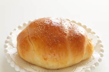 homemade butter roll on white dish with copy space