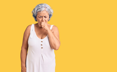 Senior woman with gray hair wearing casual clothes feeling unwell and coughing as symptom for cold or bronchitis. health care concept.
