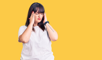 Young plus size woman wearing casual clothes with hand on head, headache because stress. suffering migraine.