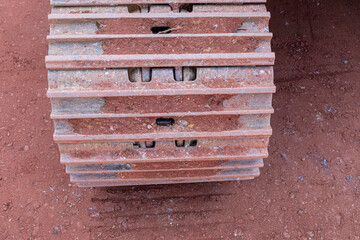 chain of an excarvator on red earth