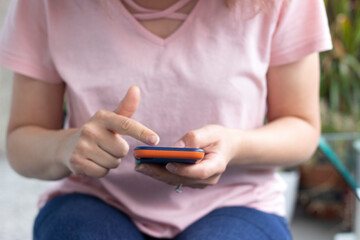 The girl holds a mobile phone in her hands, types the text. Live chat in chat on communication applications, digital media sites and social networks.