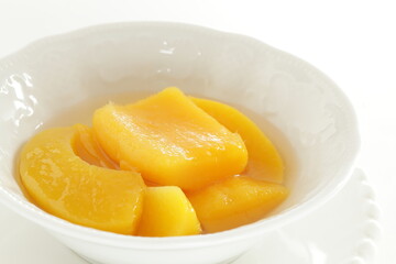 Canned food, mango and syrup in white bowl