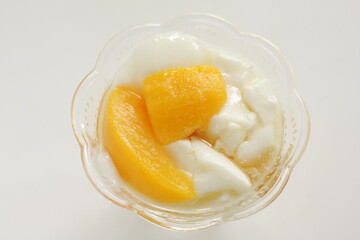 Canned food, mango and syrup in white bowl