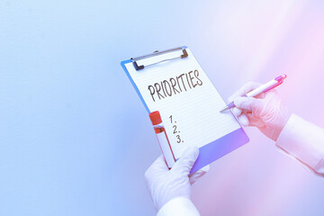 Writing note showing Priorities. Business concept for more important is the fact or state of being...