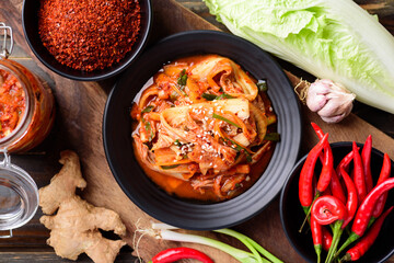 Kimchi cabbage with ingredients on wooden table, Korean food
