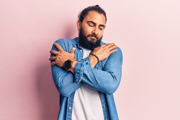 Young arab man wearing casual clothes hugging oneself happy and positive, smiling confident. self love and self care