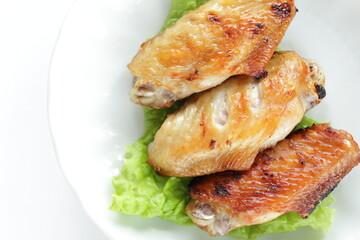 Homemade barbecue grilled chicken wing on lettuce with copy space