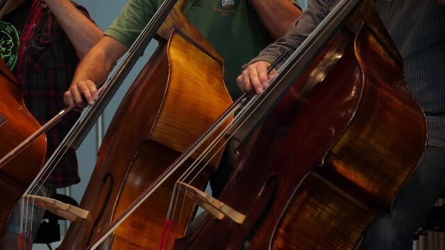 cellist playing cello in orchestra slow motion