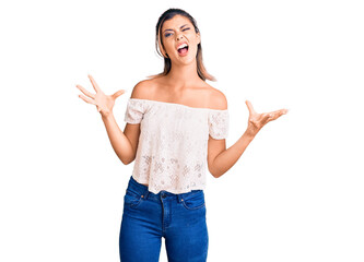 Young beautiful woman wearing casual clothes crazy and mad shouting and yelling with aggressive expression and arms raised. frustration concept.
