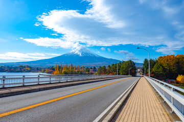 Fototapeta na wymiar Japan. Deserted road on the background of mount Fuji. Fujisan. The top of mount Fuji in the clouds. Drive to lake Kawaguchiko. Symbol Of Japan. The Japanese landscape. The Nature Of Japan.