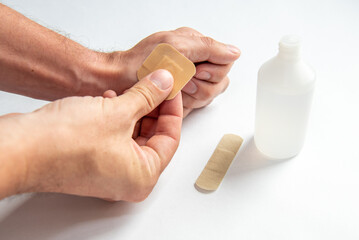 disinfecting the wound on the hand and applying a patch