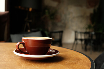 Side view cup of coffee latte on wood backround, hot coffee.