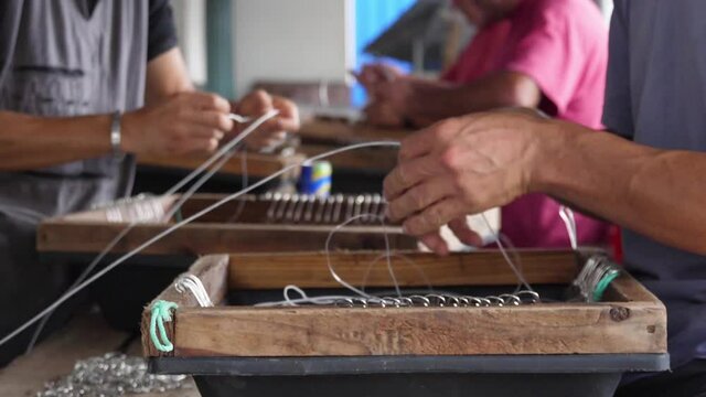 fishermen preparing fishing hooks slow motion