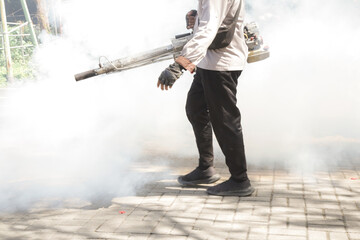 Handheld mosquitos fogger. Man fogging to eliminate mosquitos from the yard. Mosquito repellent...