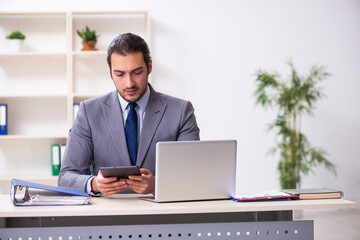 Young businessman employee sitting in the office