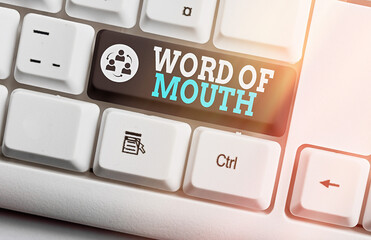 Writing note showing Word Of Mouth. Business concept for information that is transmitted without...