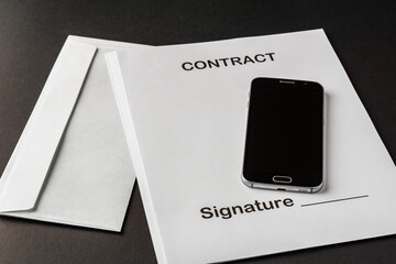 smartphone with black screen on empty contract paper and mail envelope concept of signing a business contract