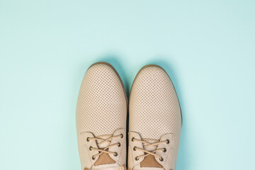 Light men's summer shoes on a blue background.