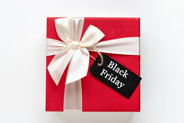Red gift box with Black Friday inscription on white background copy space