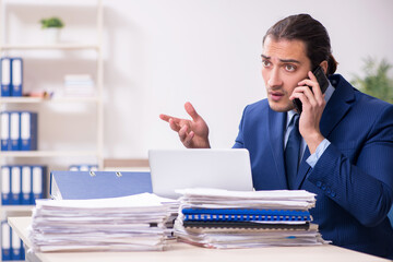 Young male employee unhappy with excessive work