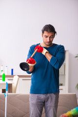 Young man husband doing plumbing at home