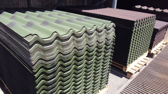 A stack of red and green colors ondulin sheets. Modern roofing material
