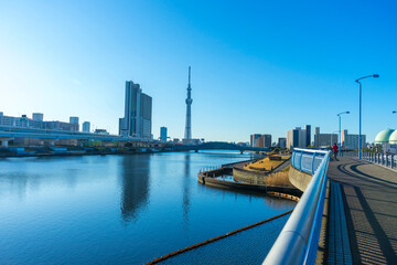 Fototapeta na wymiar Tokyo Skytree with blue sky background and Sumida river as foreground in Tokyo, Japan 