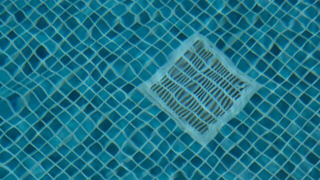 The water filter in the pool floor. Pool cleaning filter.