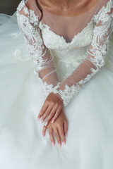 Bride's hands on a wedding dresswhite wedding dress