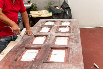 Man fixing a wood door