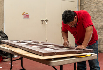 Man fixing a wood door