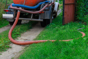 A Sewage truck working in village environment