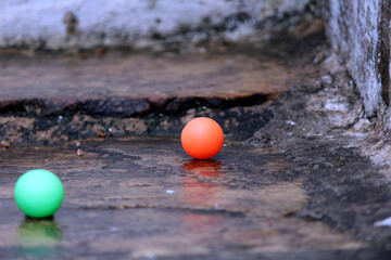 two color ball put on a ground in some wateR