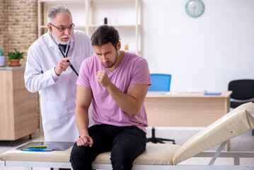 Young male patient visiting old male doctor