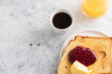 Crusty toasts with butter and jam ,coffee and orange juice. Popular breakfast in many countries.