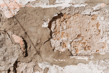 An old wall that is collapsing. Bricks visible. Textured.