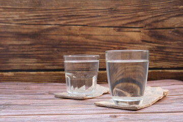 Glasses of water on the table background and space for text 