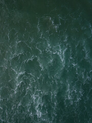 Aerial photo of small waves breaking. Taken off the coast of a small surf town in beautiful New Zealand. 