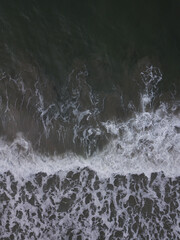Aerial photo of small waves breaking. Taken off the coast of a small surf town in beautiful New Zealand. 