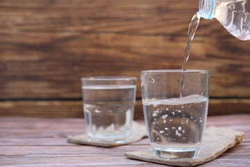 glass of water on wooden table