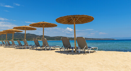 Beach chairs with umbrella with blue sky