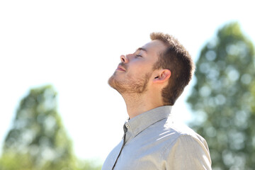 Man breathing fresh air standing outdoors