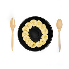 wooden spoon and black plate with a banana