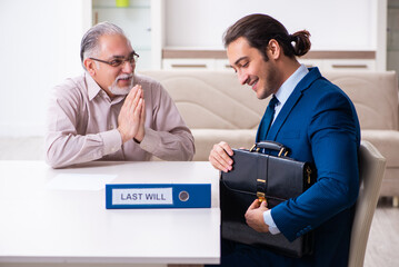 Young male lawyer visiting old man in testament concept