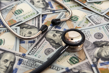 Doctor or nurse stethoscope on dollar banknotes