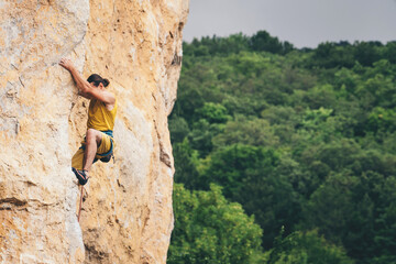 Obraz premium Man climbs a rock.