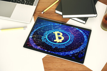 Creative Bitcoin concept on modern digital tablet display. Top view. 3D Rendering